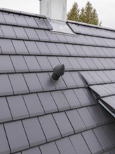 Roof detail with vent pipe on sealed fireplace area, house renovation, air conditioning renovation,