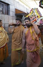 Puja at Chamundeswar Hindu Temple on Chamundi Hill, Indian men wear the statue of a Hindu goddess,