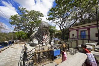 Nandi bull, Indian pilgrims at the monolithic statue of a bull on Chamundi Hill, Mysore or Mysore,