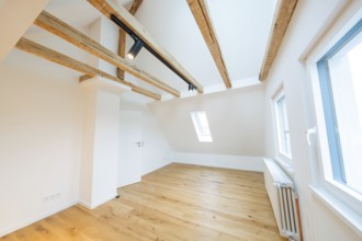 Renovated attic room with beams, skylights and bright, friendly atmosphere, house renovation,