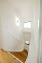 Light wooden staircase in white, minimalistic staircase with window, house renovation, climate