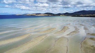A sandy beach at low tide, photograped with a drone