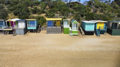 A row of beach houses on a sunny day on an Australian beach, seen from above