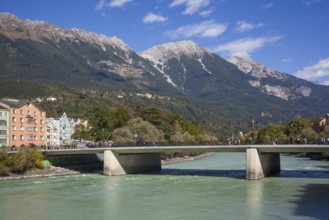 Colourful row of houses in Mariahilfstraße on the Inn River, Inn Bridge and mountains of the