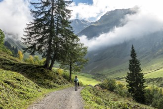 Female hiker on hiking trail in the Dietersbach Valley from Gerstruben to Alpe Dietersbach,