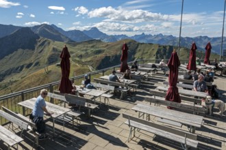 Terrace of the restaurant Gipfelstation Fellhornbahn, behind mountains of the Allgäu Alps,