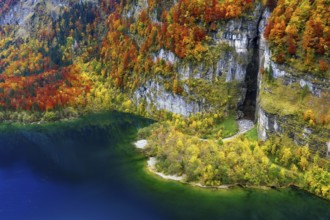 Aerial view of autumn-colored Klöntalersee, rugged rock formation with peninsula, Canton of Glarus,