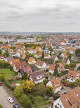 Autumn residential district with red roofs and solar panels under overcast sky, Metzingen, Germany