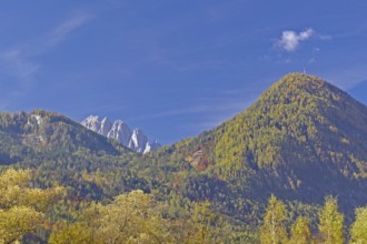 Autumn alpine slopes with round and jagged peaks under clear, deep blue sky, Lienz Dolomites, Drau