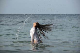 Woman with long hairs in the sea