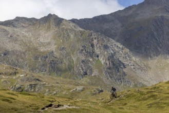 Mountain biker on the trail downhill at Passo del Sole, Olivone, Tessin, Switzerland