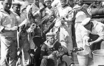 Crew members torpedo boat griffin with fish, cod (Gadus morhua), which were killed by water bombing