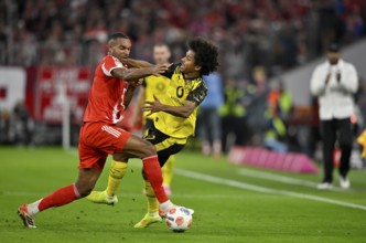 Duel, action Jonathan Tah FC Bayern Munich FCB (04) against Karim Adeyemi Borussia Dortmund BVB