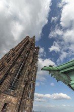 Strasbourg's Gothic cathedral stands majestically under a cloudy sky. In the background is an