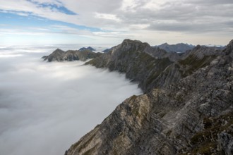 View from the Nebelhorn summit to mountains of the Allgäu Alps, mountains rising from fog in the