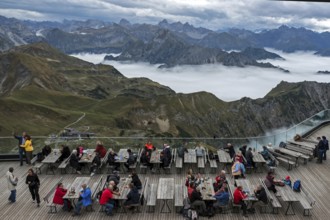 Restaurant at the Nebelhorn summit with views of the Allgäu Alps, mountains rising from fog in the