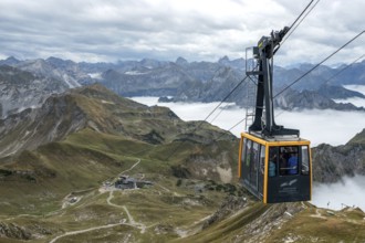 View from Nebelhorn summit to Nebelhorn cable car cabin, mountains of the Allgäu Alps behind,