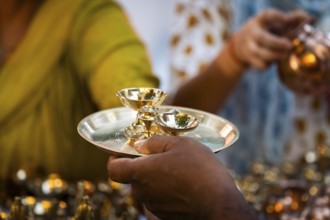 People shop for bronze and other metal items at a roadside stall on Dhanteras, in Guwahati, Assam,