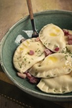 Dumplings, with fried prosciutto, a traditional dish of Polish cuisine, dumplings, top view,
