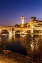 Ponte Pietra (Stone Bridge) over Adige River at evening, built by the Romans in 100 BC. Verona,