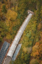 Aerial view of a railway line with tunnel surrounded by autumn trees, Hermann-Hesse-Bahn