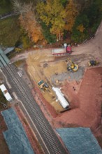 Construction work with heavy machinery on a railway line in autumn forest, Hermann-Hesse-Bahn