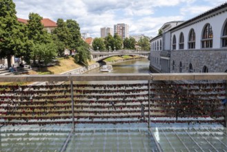 Love locks hang in several rows on the railing of the Mesarski Most (butcher's bridge) over the