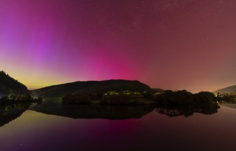 Nocturnal sky with aurora borealis. The Neckar river near Neckargemünd, Rhein-Neckar district,