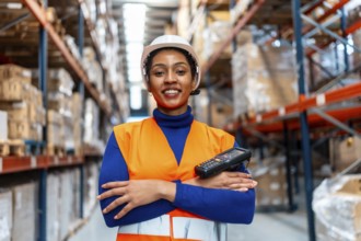 Female logistics operator wearing safety vest and hard hat, standing confidently with a barcode