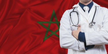 Male doctor with stethoscope on Morocco flag. Doctor holding stethoscope on Morocco flag