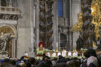 View of heads of faithful in the foreground at the bottom of the picture Pope Saint Father with