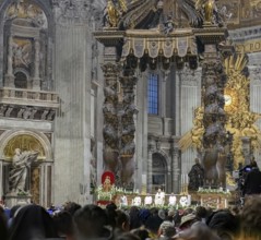 View of heads of faithful in the foreground at the bottom of the picture is Pope Saint Father with