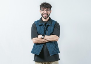 Portrait of cool and handsome casual man with glasses and crossed arms. Smiling and handsome guy