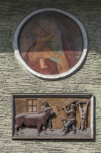Relief depiction of a house slaughter above a saint at a town house, Going am Wilden Kaiser, Tyrol,