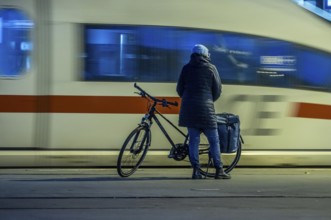 Cyclists waiting for the train, in Essen main station, on the platform, North Rhine-Westphalia,