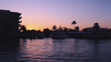 Yachts and sailboats in Fort Lauderdale canals in Florida at sunset