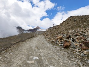 Mountain hiking trail in alpine mountain scenery in the area of the Tiefenbach Glacier near Sölden,