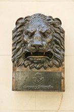 Bronze letterbox in the shape of a lion's head with the inscription Correos y Telegraficos in Old