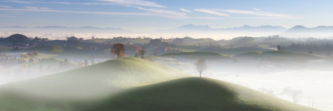 Panorama of a misty hilly landscape near Hirzel at sunrise, Canton of Zug, Switzerland