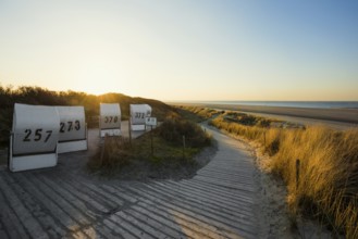 Beach chairs in the dunes and blue sky in winter, sunset, Spiekeroog, East Frisian Islands, Lower