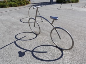 Bicycle, stainless steel bicycle rack, casts shade, bicycle parking, Aalborg, Jutland, Denmark