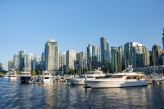 Sailing boats in marina, skyscrapers on the promenade, Coal Harbour, Vancouver, British Columbia,