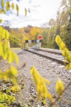 End of a railroad track with a barrier, surrounded by autumn trees, ZOB Calw, Hermann Hessebahn,
