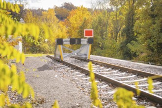 Railway track ends with a barrier surrounded by autumnal nature, ZOB Calw, Hermann Hessebahn, Calw,