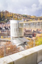 Autumn cityscape with a modern building and hill in the background, ZOB Calw, Hermann Hessebahn,