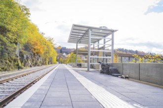 Empty train station with tracks and waiting room in autumn surroundings and modern design, ZOB
