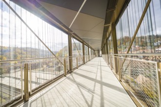 Modern footbridge with view of sunny landscape and metal grids, ZOB Calw, Hermann Hessebahn, Calw,