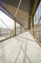 Modern bridge with sunbeams and grid-shaped architecture, spanning a gorge, ZOB Calw, Hermann