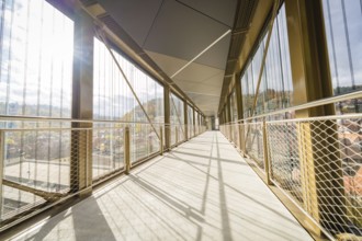 Long, modern footbridge with shadows cast by metal grids, ZOB Calw, Hermann Hessebahn, Calw,