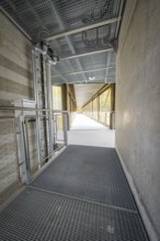 Industrial-style corridor with mesh floor and pipes, ZOB Calw, Hermann Hessebahn, Calw, Germany